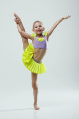 little gymnast girls in the studio gray background