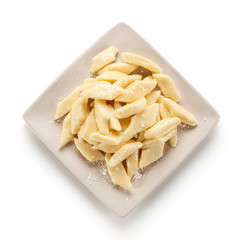Potato noodles - dumplings on white background