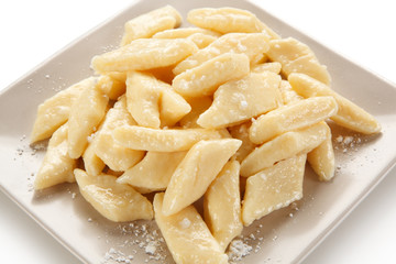 Potato noodles - dumplings on white background