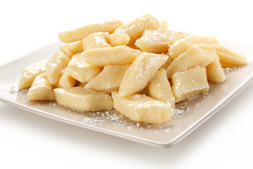 Potato noodles - dumplings on white background