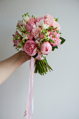 The bride's bouquet of soft pink peonies and white roses . Wedding floristry. Classic form