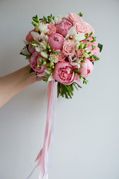 The bride's bouquet of soft pink peonies and white roses . Wedding floristry. Classic form