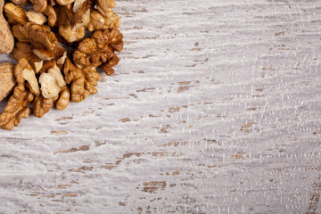 Mix of different type of nuts on wooden background in studio photo