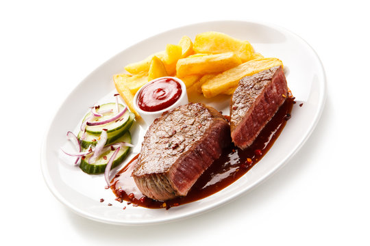 Grilled beefsteak with french fries on white background
