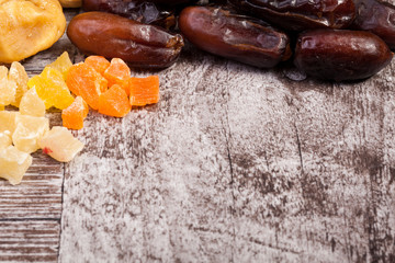 Mix of different dried fruits on wooden background in studio photo