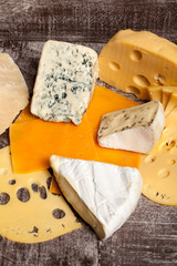 Mix of different type of cheese on wooden background. Healthy food. Snacks and products
