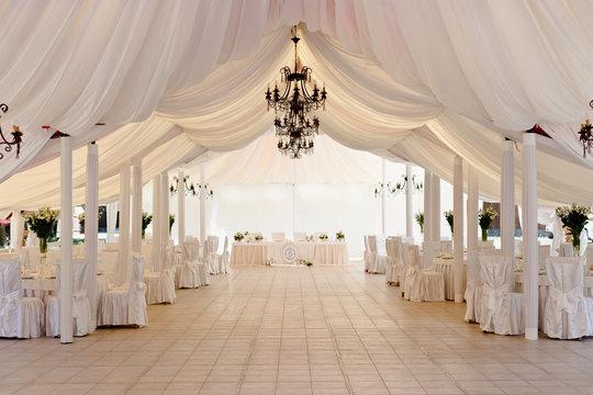 Marquee for the celebration of the wedding. Beautiful white interior with white draperies