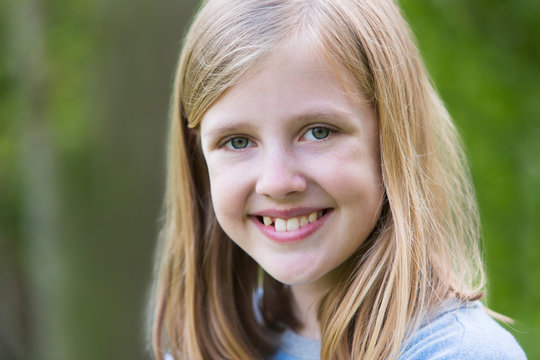 Portrait Of Smiling Pre Teen Girl Outdoors