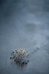 wedding hair decoration hairpin made of grey beads plan on black light grey wood background copyspace