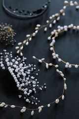wedding hair jewelry close-up on black blue light grey wooden background