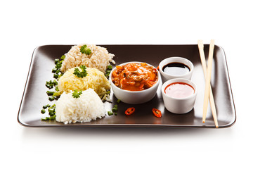 Rice dish with various sauces on white background