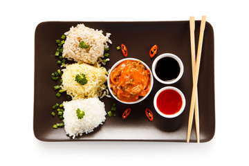 Fototapeta na wymiar Rice dish with various sauces on white background
