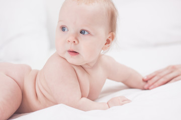 Four month kid holding mother hand, white background.