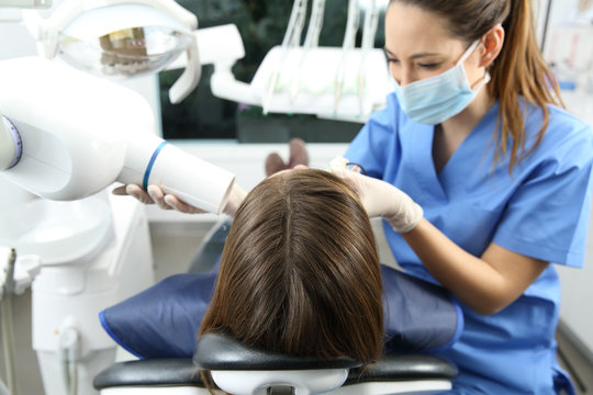 Dentist taking x-ray of teeth