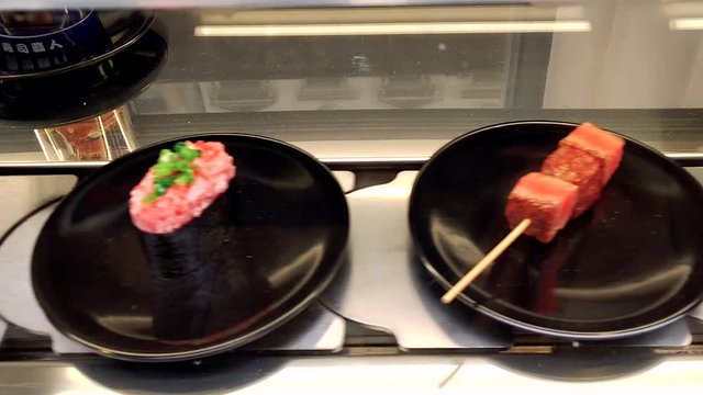 Conveyor sushi belt. Japanese food belt. Sushi tray on conveyor belt in restaurant