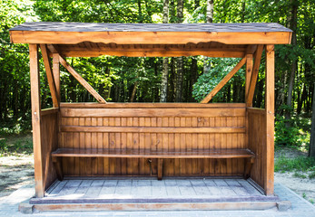 A wooden gazebo in the woods