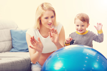 Young Happy Pregnant woman playing with son