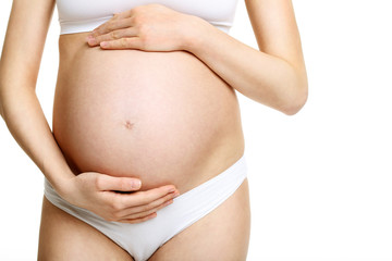Pregnant woman posing over white background