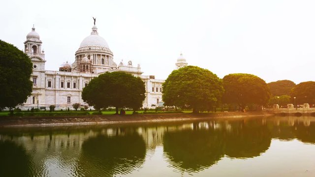 Victoria Memorial Hall in Calcutta, India. With a reflection in a pond. Popular park among locals and a touristic landmark. Time-lapse
