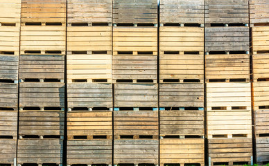 Stack of used wooden crates or boxes.