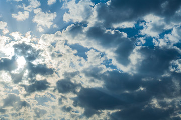 Dramatic clouds in the sunlight against the blue sky