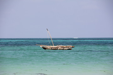 Fototapeta na wymiar Dhow / Traditional sailing vessel at the beach of Kiwengwa, Zanzibar Island, Tanzania, Indian Ocean, Africa