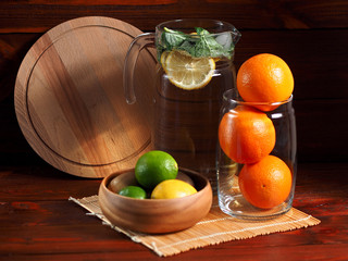 Still life of crockery and citrus on a wooden background
