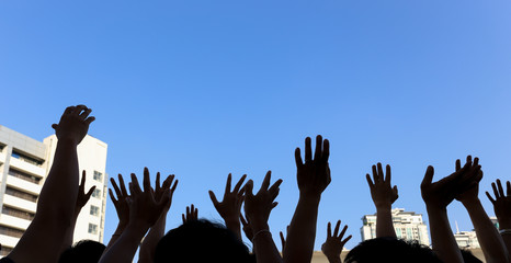 community initiative or volunteering concept, hands of group of people in the blue sky background,...