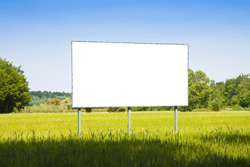 A blank advertising billboard in a grass field - image with copy space