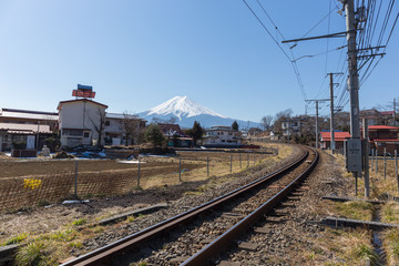 Fototapeta na wymiar curved train railway and Fuji mountain in the background with blue sky