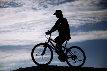 Fototapeta premium Silhouette of Mountain bike.Sport and healthy life.Extreme sports.Mountain bicycle and man.Life style outdoor extreme sport