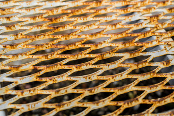 Detail of an old, rusted iron ornament lying on the ground