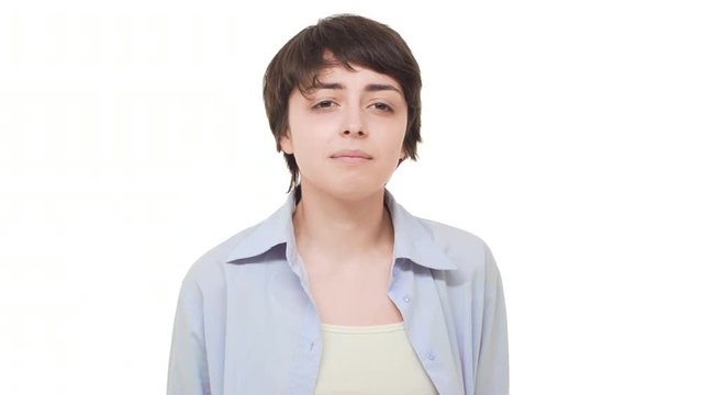 Young Caucasian female with short haircut wrinkling her face from four smell over white background