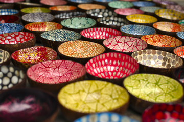 Decorated hand painted wooden plates on local market in Vietnam