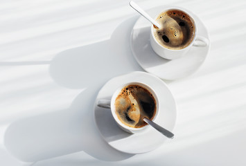 two cup of coffee on white table