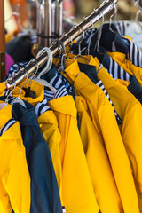Naklejka premium Bright raincoats hanging at a fashion store