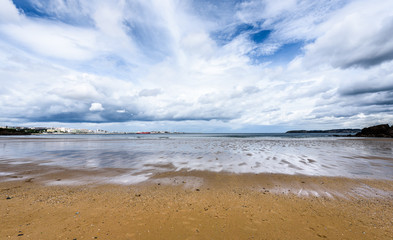 Atlantic sandy beach in Spain with city of Coruna background.