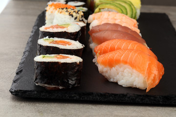 close up of sashimi sushi set with chopsticks and soy - sushi roll with salmon and sushi roll with smoked eel, selective focus.