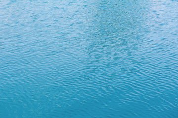 blue swimming pool with sunny reflections abstract for background