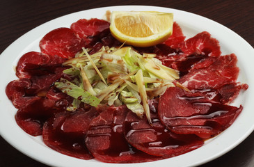 uncooked meat : raw fresh beef pork fillet ready to cooking with garlic and green stuff over wood isolated over white background