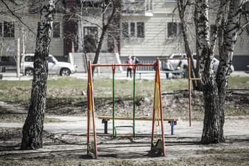 Fototapeta na wymiar Children's swing in the summer in the yard