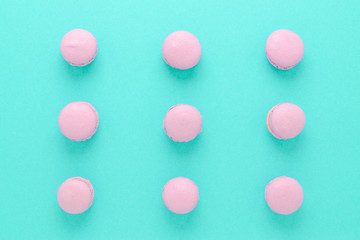 pink macaroons homemade on turquoise background top view