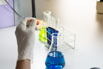 Droping liquid in Chemical test tubes in laboratory