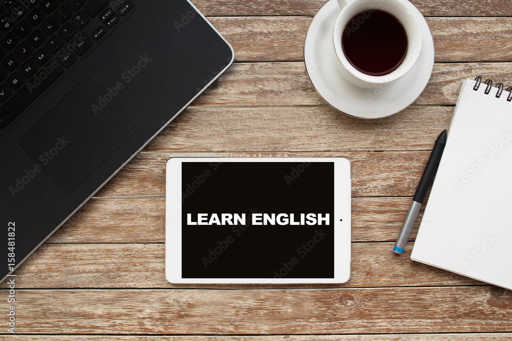 Poster tablet on desktop with learn english text.