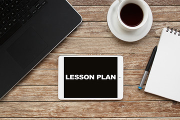 Tablet on desktop with lesson plan text.