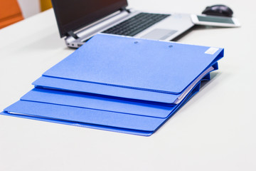 file folder with documents and Notebook background  on white table in meeting room