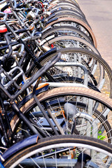 Fototapeta na wymiar front wheels of bikes in bicycle rack in Amsterdam