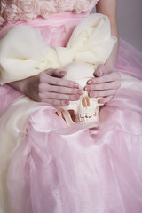 woman in a silk dress holds a skull
