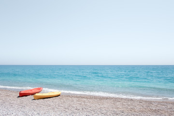 Two kayaks on sea edge