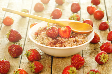 Cooked oatmeal, berries and strawberry jam